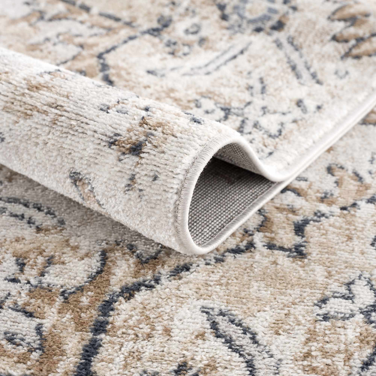 Hauteloom Mudgee Area Rug, folded display, featuring intricate patterns and warm tones in a stylish rug for living spaces.