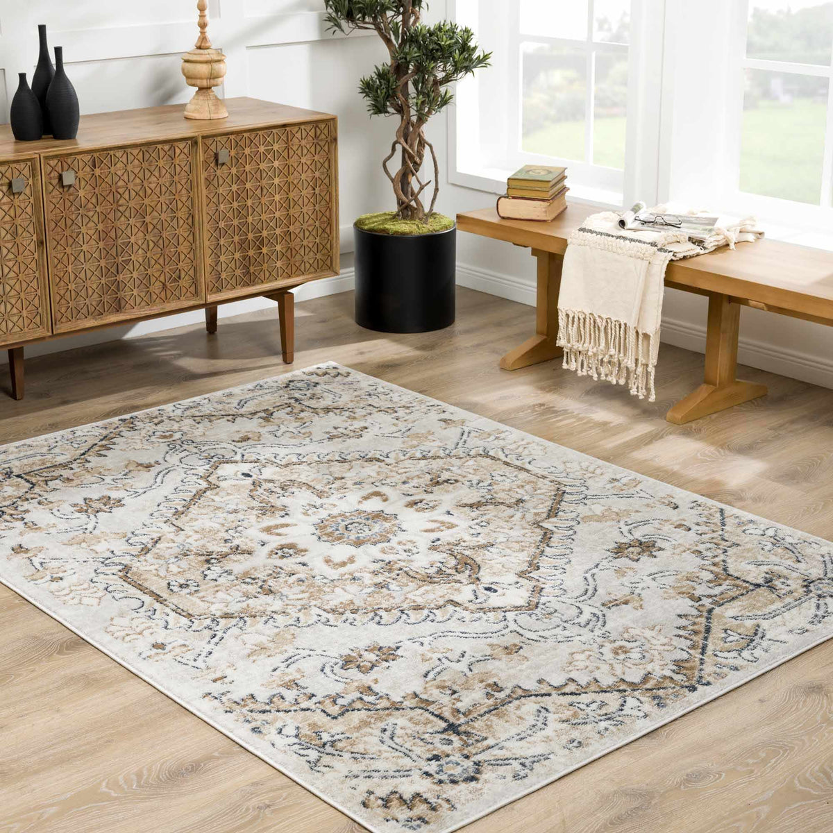 Hauteloom Mudgee Area Rug displayed in a living room, featuring a textured design in neutral tones on a hardwood floor.