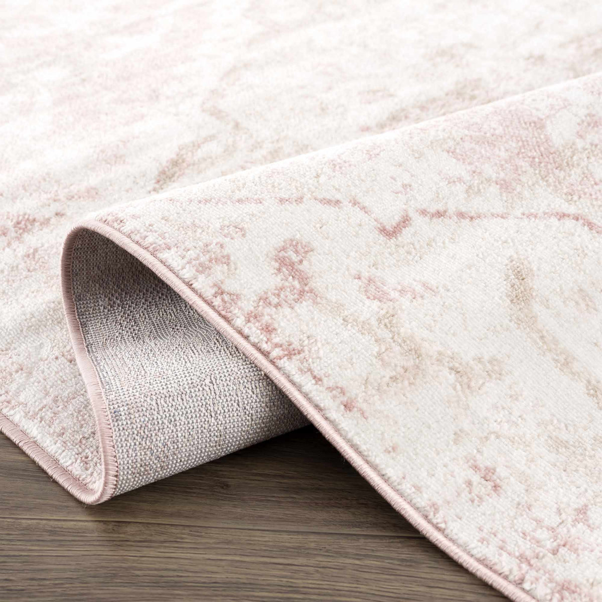 Folded Leonora area rug by Boutique Rugs showing intricate patterns and soft texture in neutral tones.
