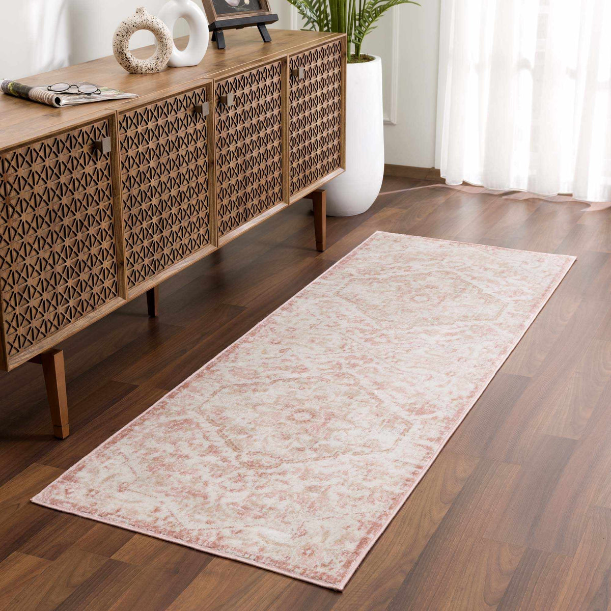 Elegant Leonora area rug from Boutique Rugs displayed in a room scene, featuring intricate patterns and warm tones.