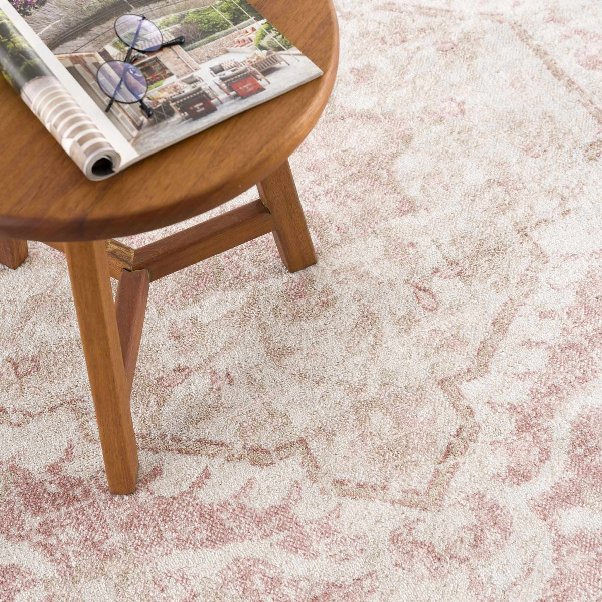 A stylish Leonora area rug by Boutique Rugs featuring intricate patterns and warm tones, displayed on a neutral floor.
