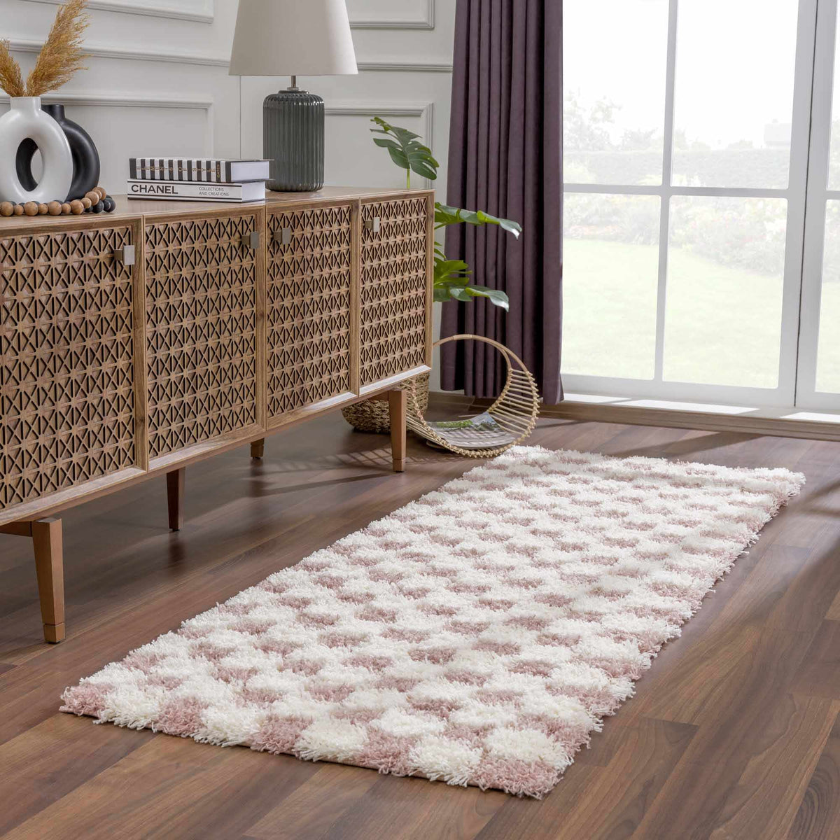 Pink checkered shag rug by Boutique Rugs displayed in a room scene, showcasing its soft texture and vibrant pattern.