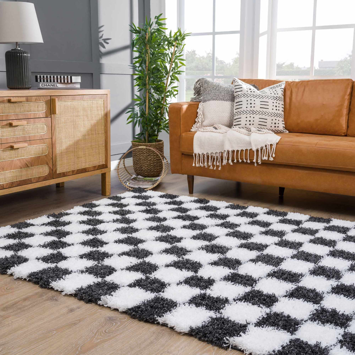 Black and white checkered area rug by Boutique Rugs displayed in a room setting with stylish furniture and decor.