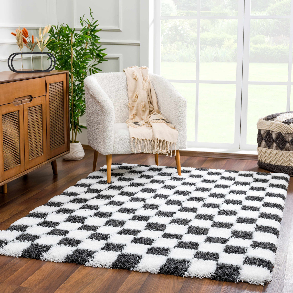 Black and white checkered area rug by Boutique Rugs, stylishly displayed in a modern room setting.
