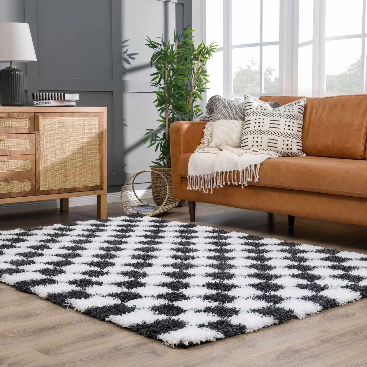 Black and white checkered area rug by Boutique Rugs, stylish geometric pattern in a cozy room setting.