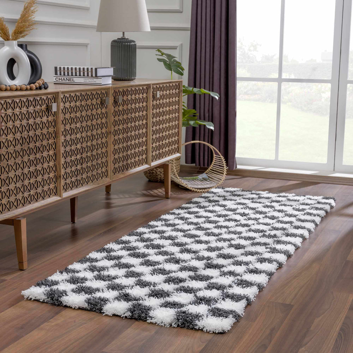 Black and white checkered area rug by Boutique Rugs, showing a stylish geometric design in a modern living room scene.