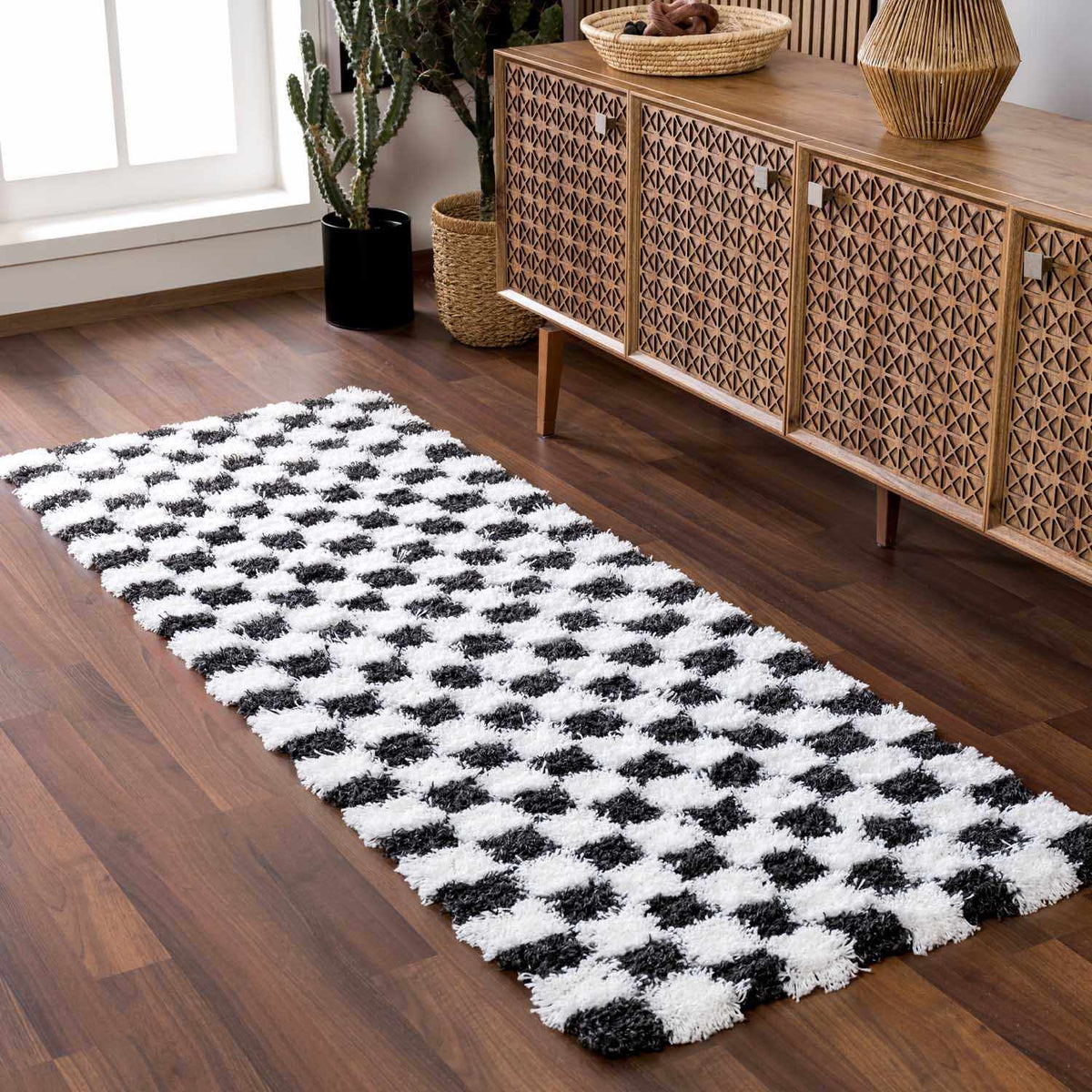 Black and white checkered area rug by Boutique Rugs, styled in a modern living room setting.