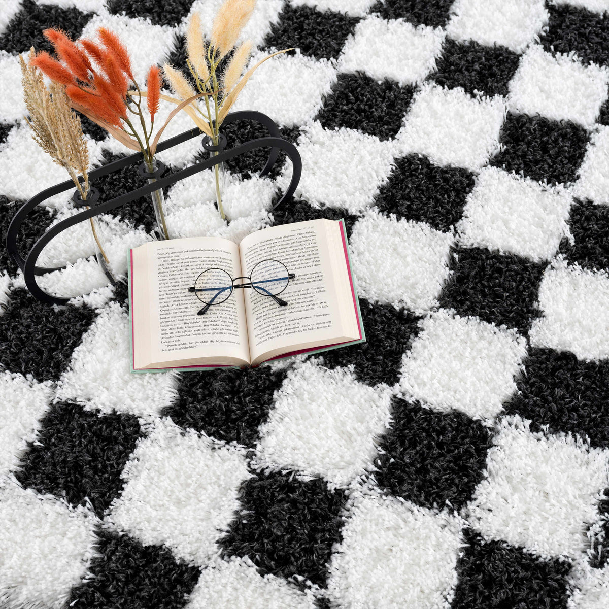Black and white checkered area rug from Boutique Rugs, showcasing a stylish geometric pattern in a modern room setting.