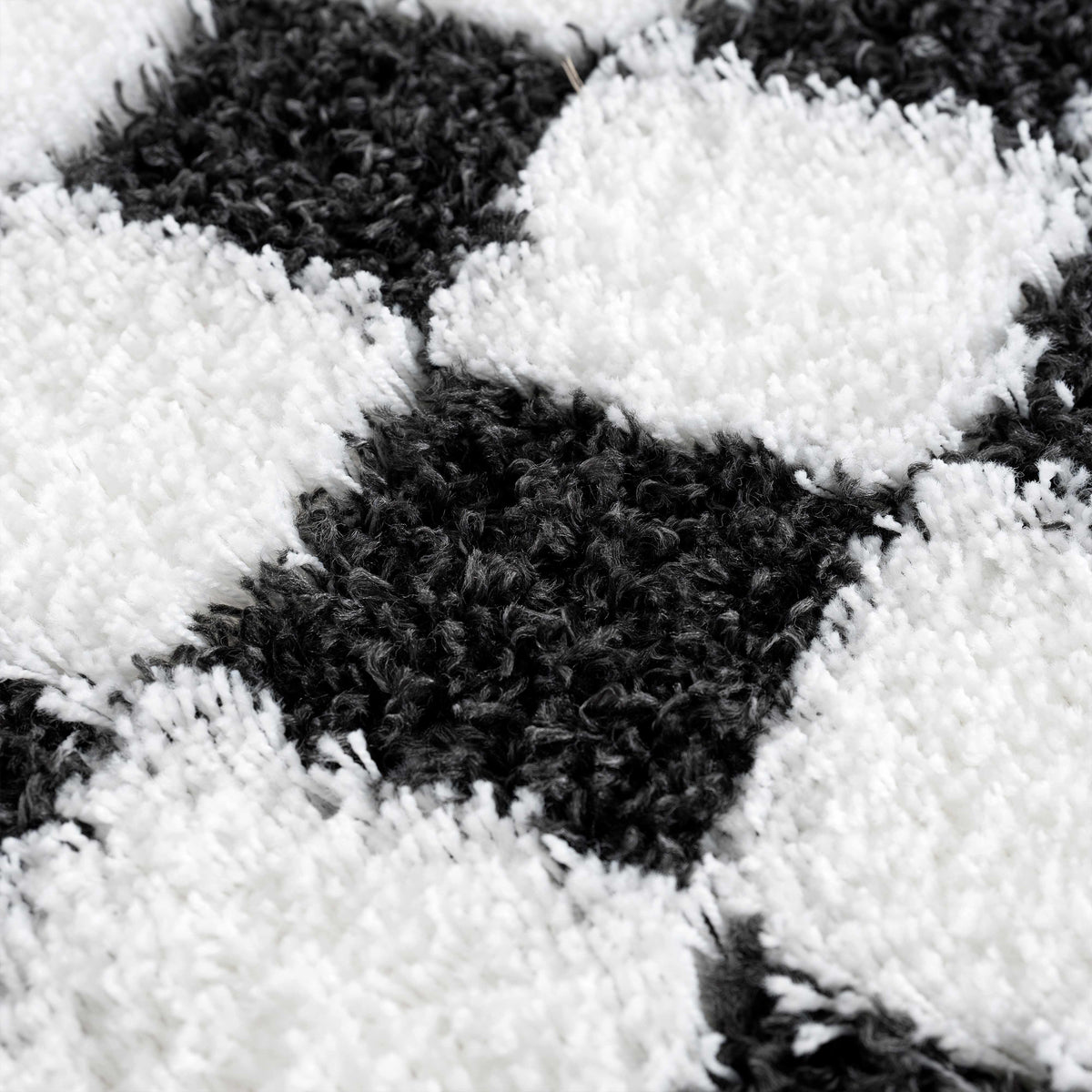 Black and white checkered area rug by Boutique Rugs, textured geometric pattern, soft pile, perfect for modern living spaces.