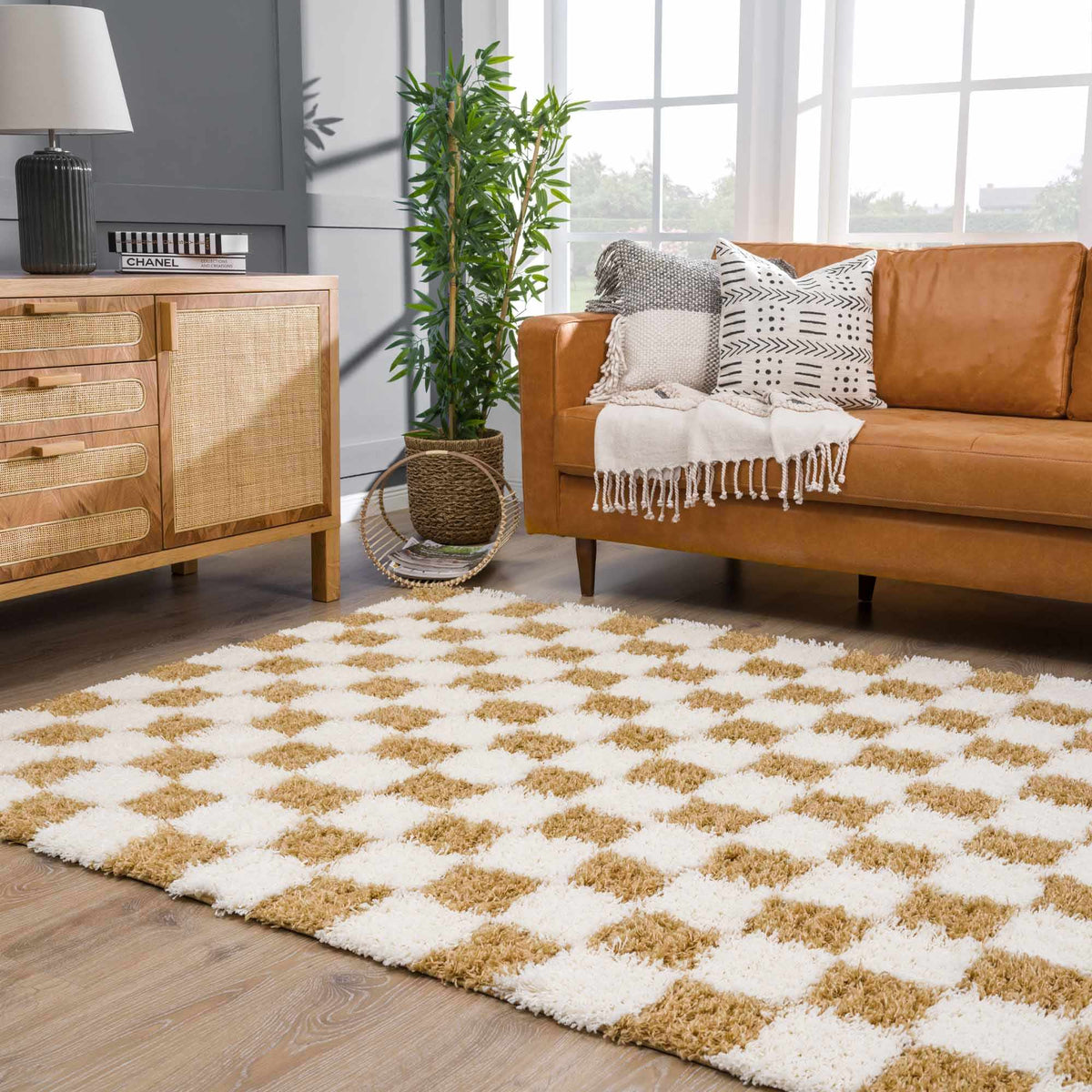 Boutique Rugs Atira Mustard Checkered Area Rug in a living room setting, showcasing a vibrant yellow and gray checkered pattern.