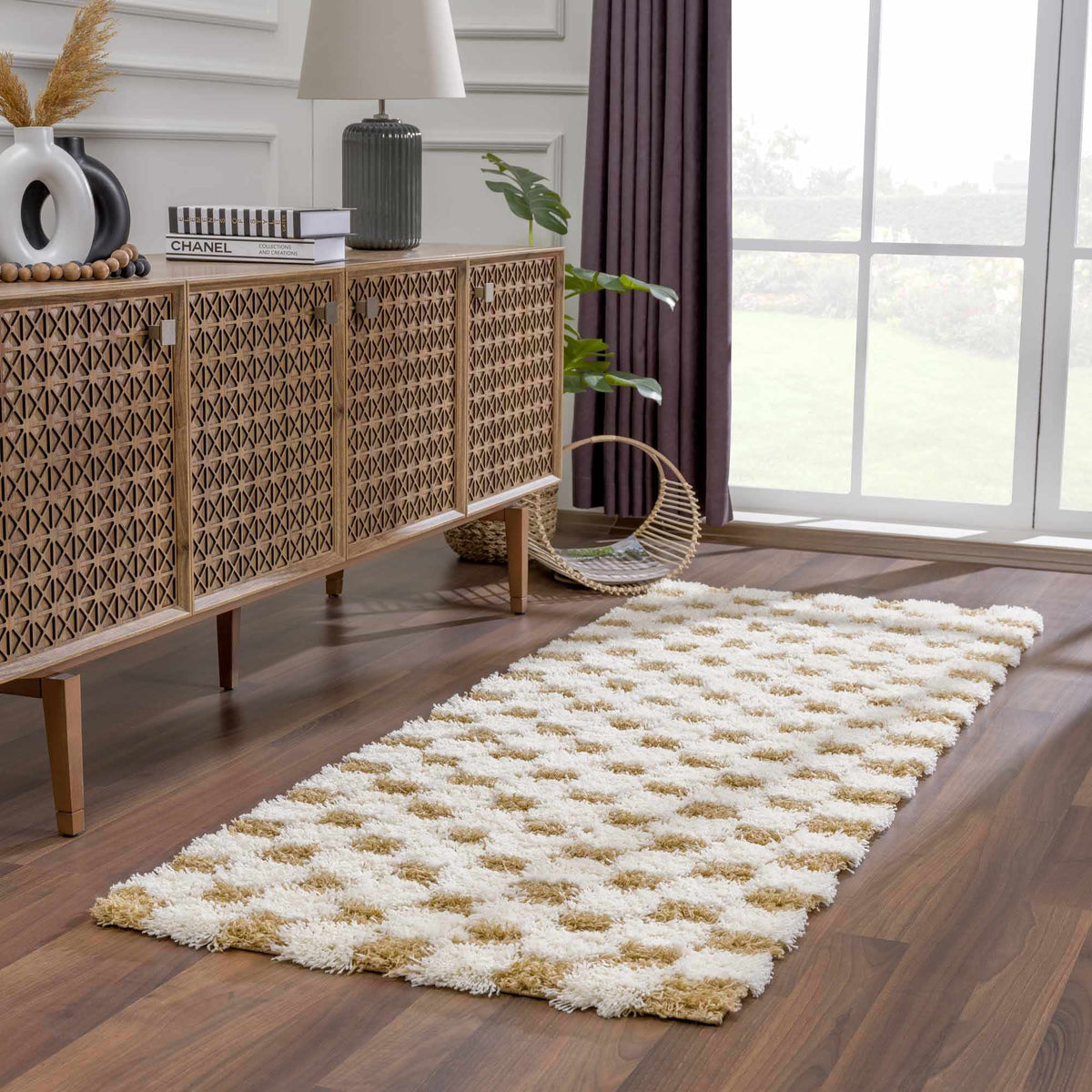 Atira Mustard Checkered Area Rug by Boutique Rugs displayed in a cozy living room setting with furniture and decor.