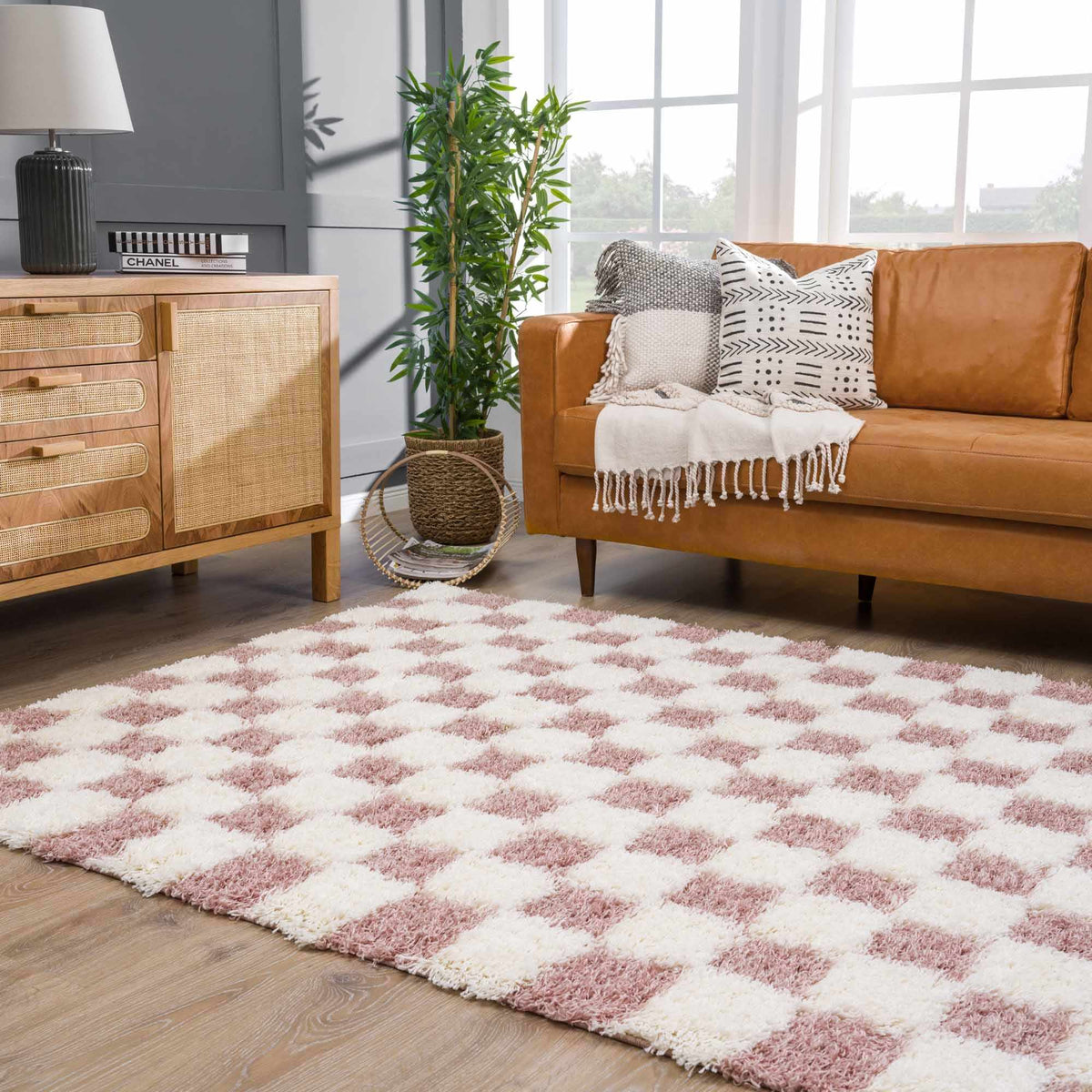 Pink checkered shag rug from Boutique Rugs in a cozy room setting, showcasing its soft texture and vibrant pattern.