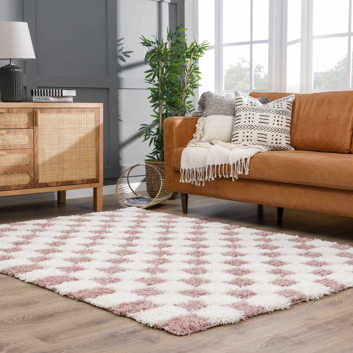 Pink checkered shag rug from Boutique Rugs, styled in a cozy living room scene, showcasing soft texture and bold pattern.