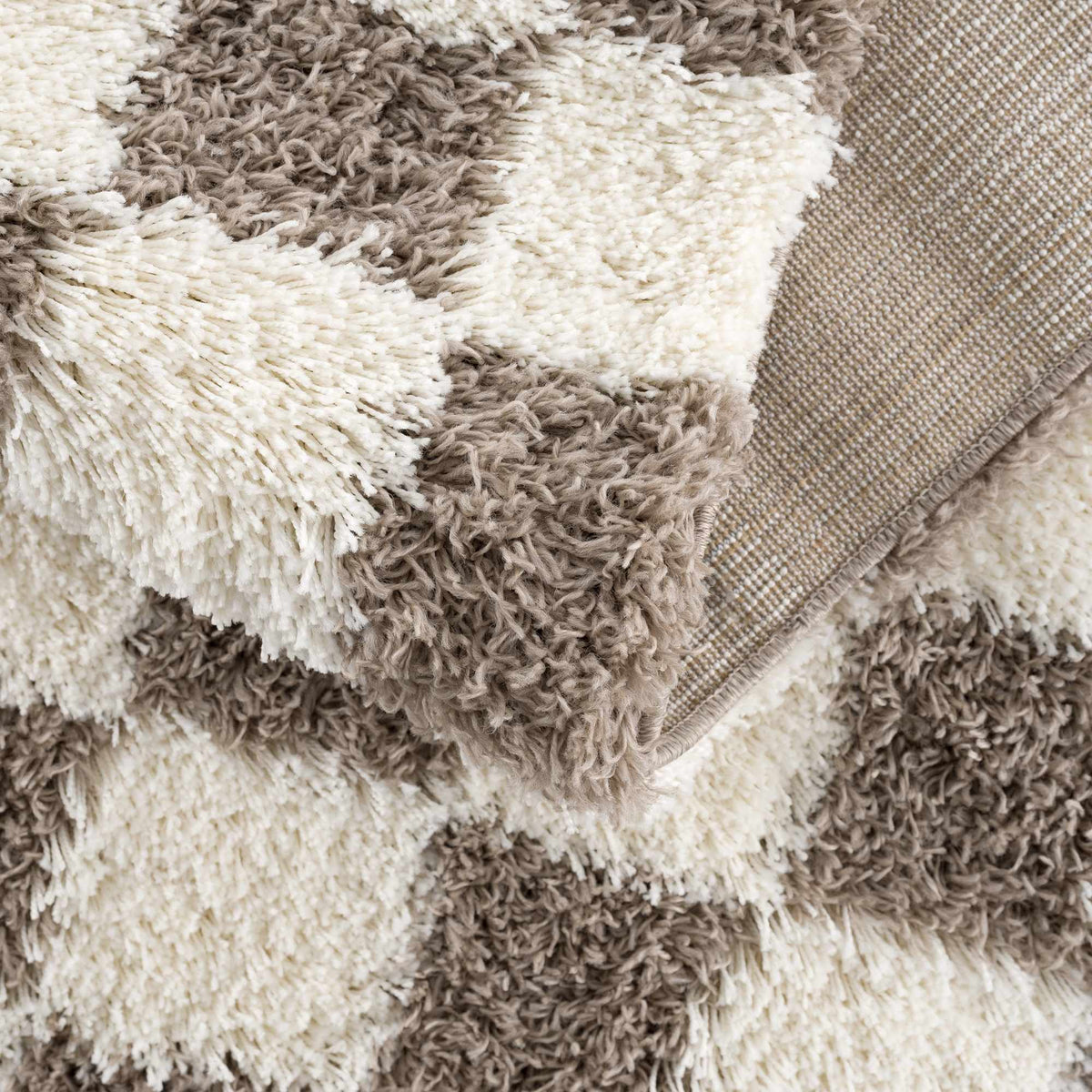 Brown checkered area rug from Boutique Rugs, folded to show its pattern and texture, perfect for living room or bedroom decor.