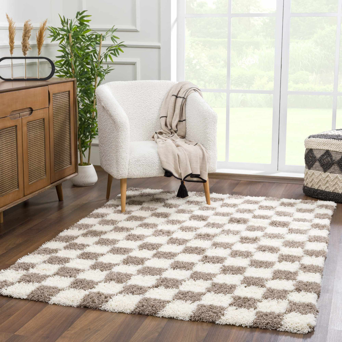 Atira brown checkered area rug by Boutique Rugs, displayed in a cozy living room setting with furniture and decor.