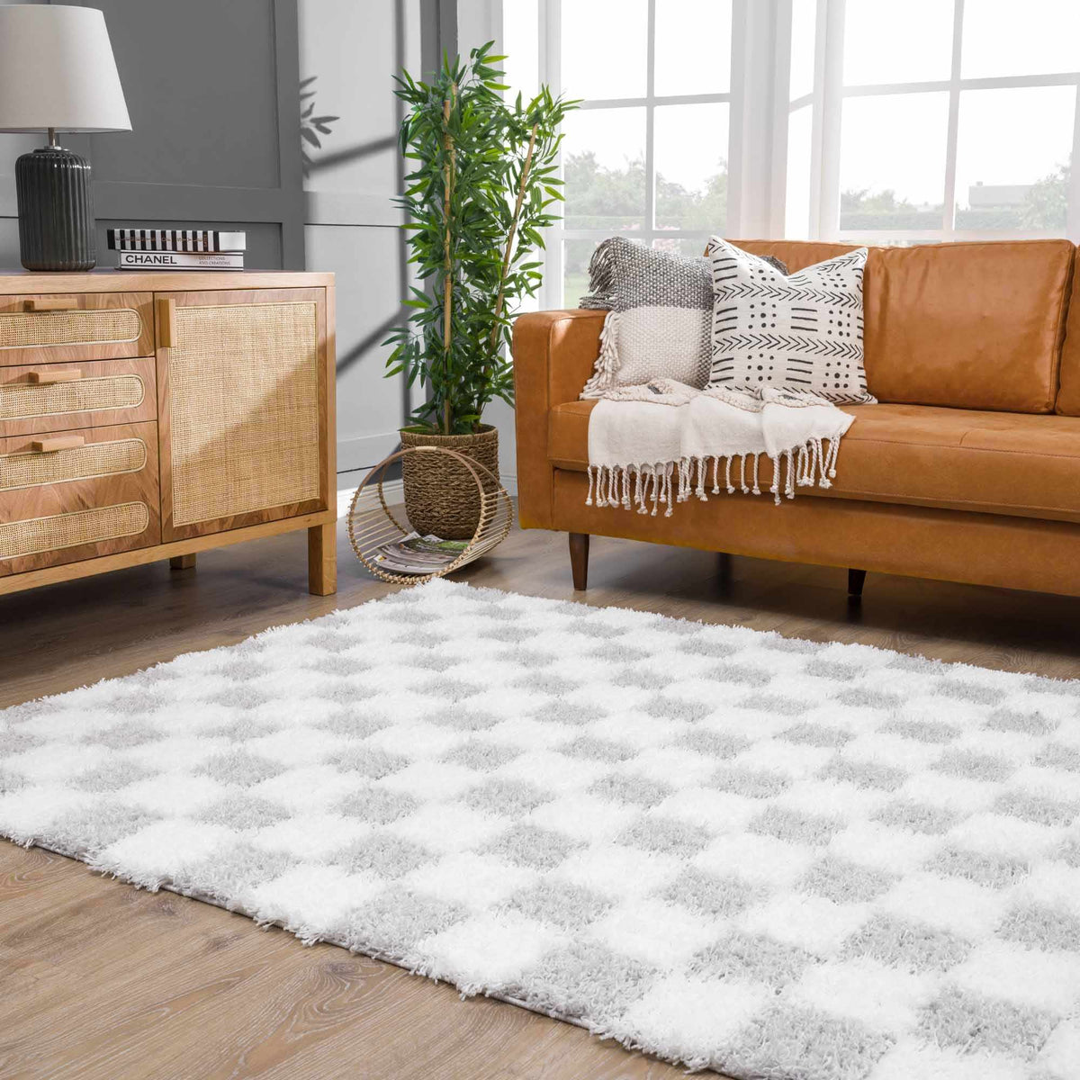 Gray checkered area rug by Boutique Rugs displayed in a room scene with furniture and decor.