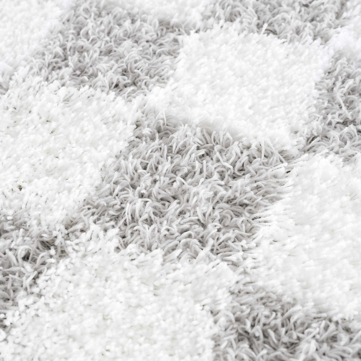 Gray checkered area rug by Boutique Rugs, featuring textured fabric and modern design in a cozy living space.