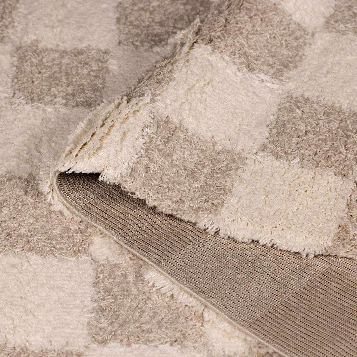 Light brown checkered area rug from Boutique Rugs, featuring a folded design and checkered pattern, suitable for living spaces.