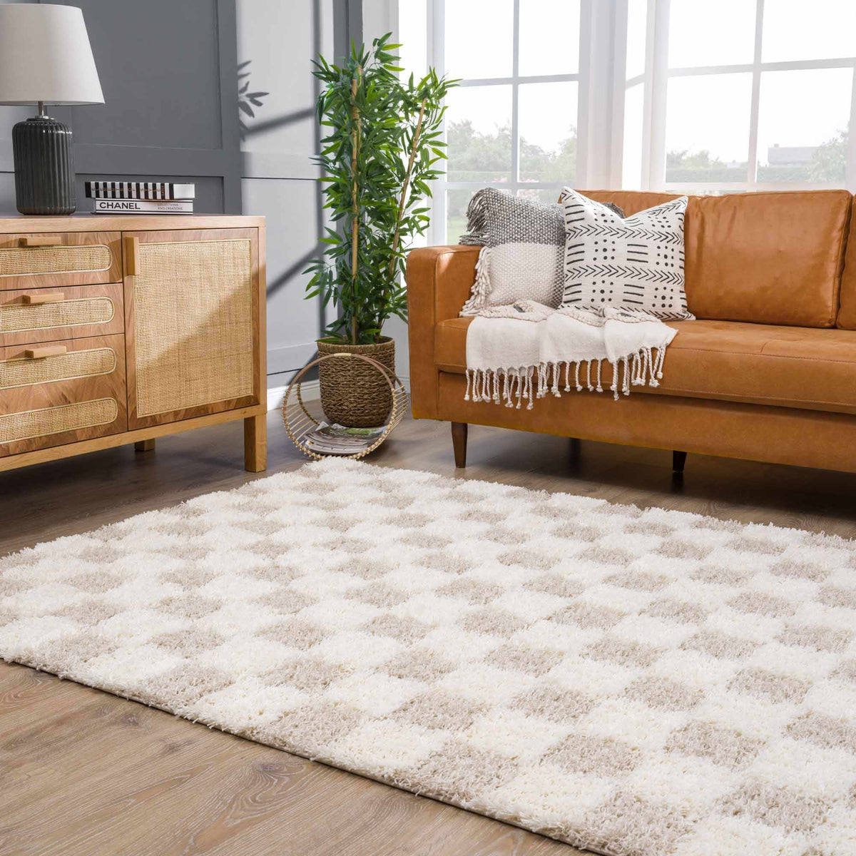 Light brown checkered area rug from Boutique Rugs, shown in a living room setting with furniture and decor.