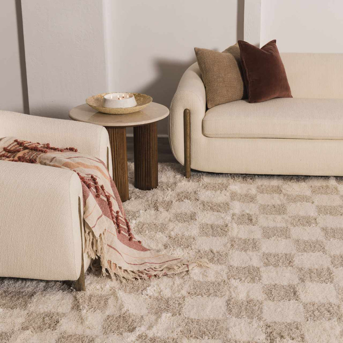 Light brown checkered area rug from Boutique Rugs in a room scene, showcasing its pattern and texture on the floor.