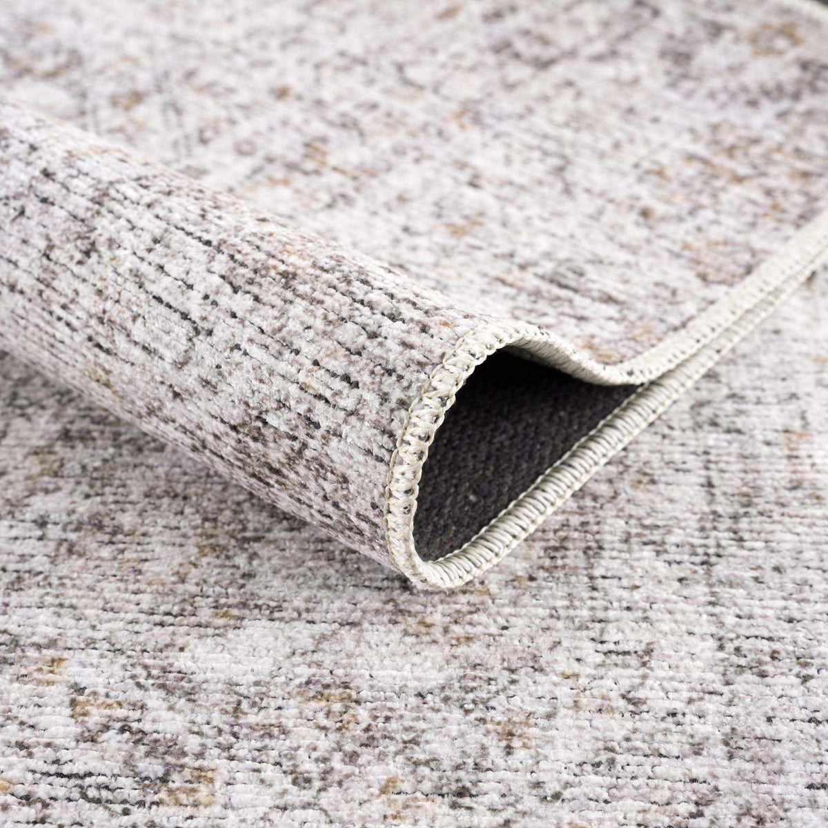 Folded Boutique Rugs Washable Parkerfield Area Rug in neutral tones, showcasing its soft texture and versatile design.