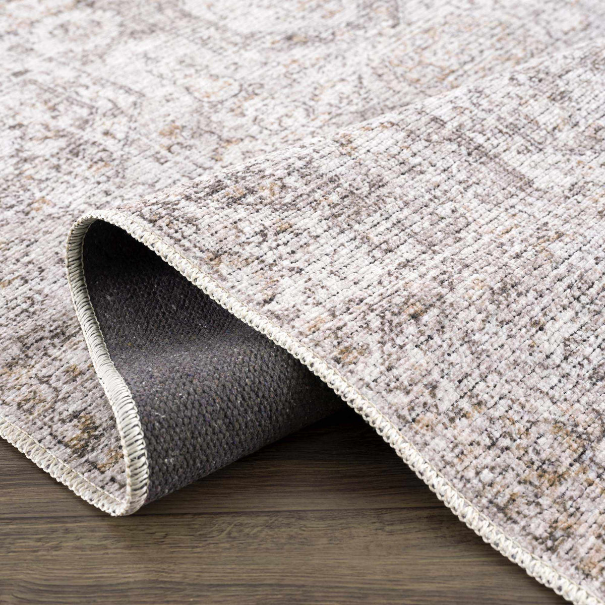 Folded washable Parkerfield area rug by Boutique Rugs, featuring a textured design in neutral tones, suitable for modern living spaces.