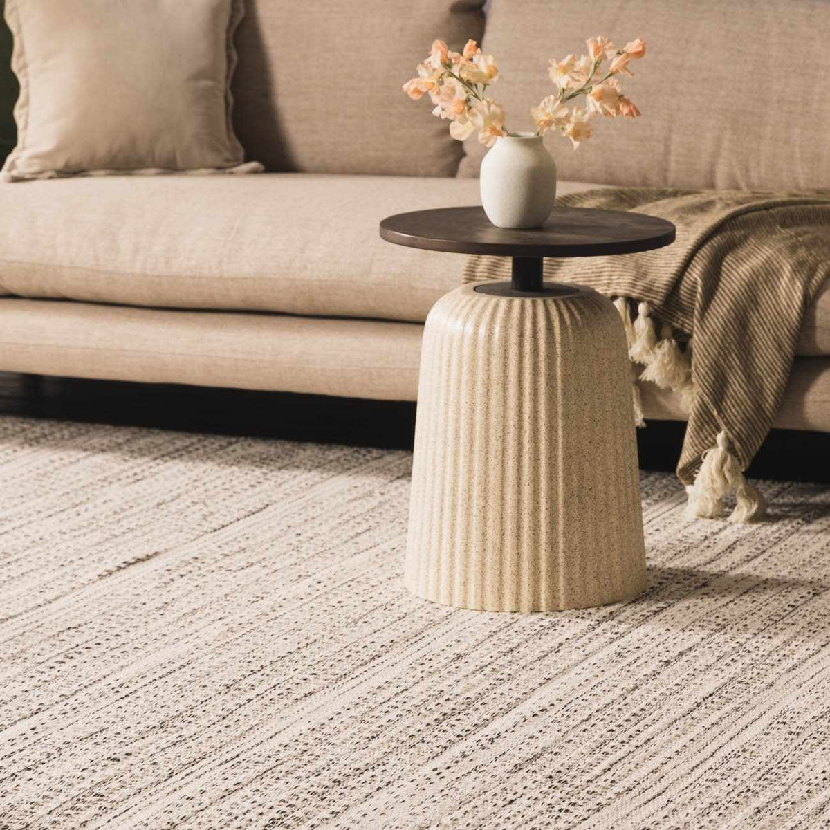 Hauteloom Williford Wool Area Rug in neutral tones, displayed in a living room setting with modern furniture.