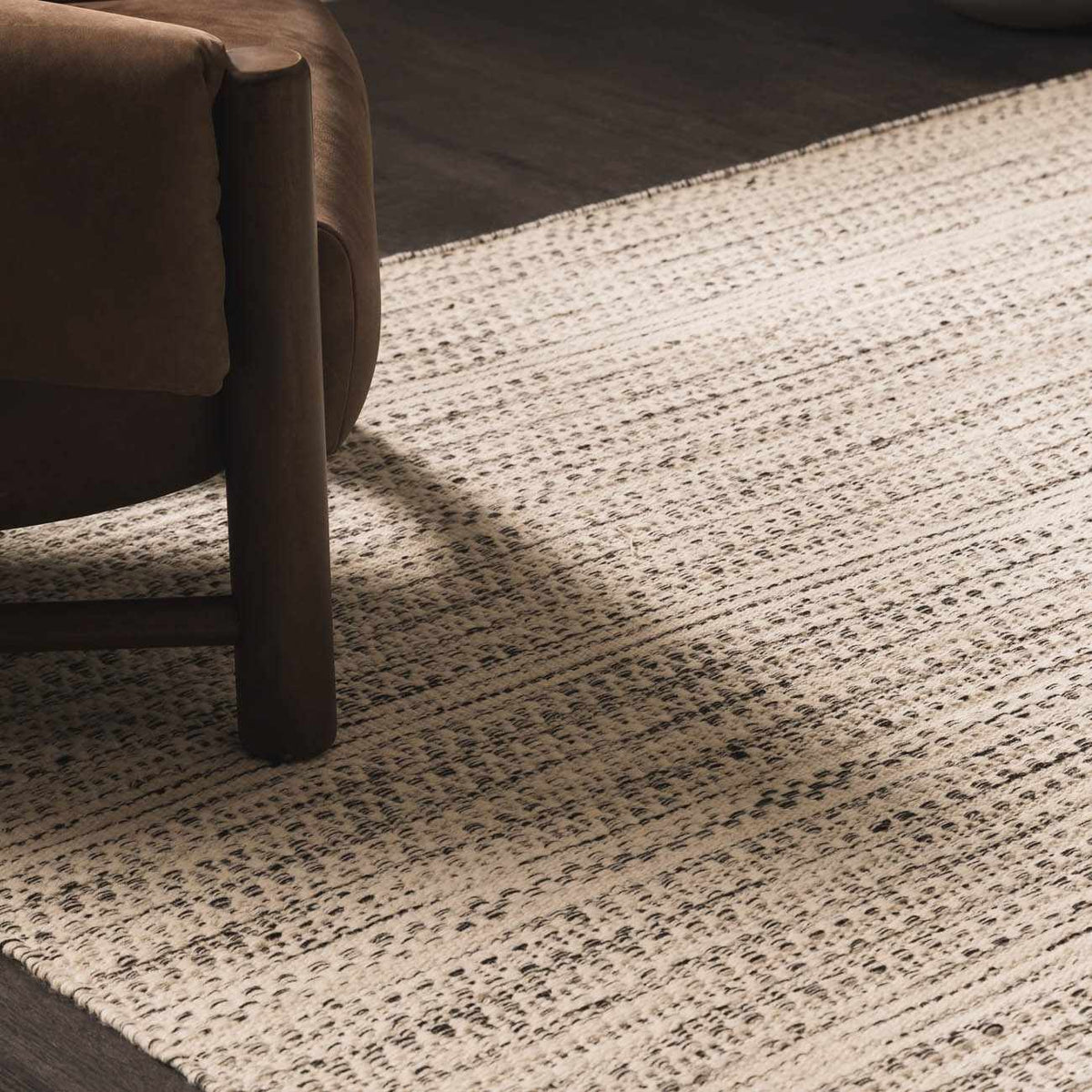 Hauteloom Williford Wool Area Rug displayed in a living room setting with neutral tones and contemporary decor.