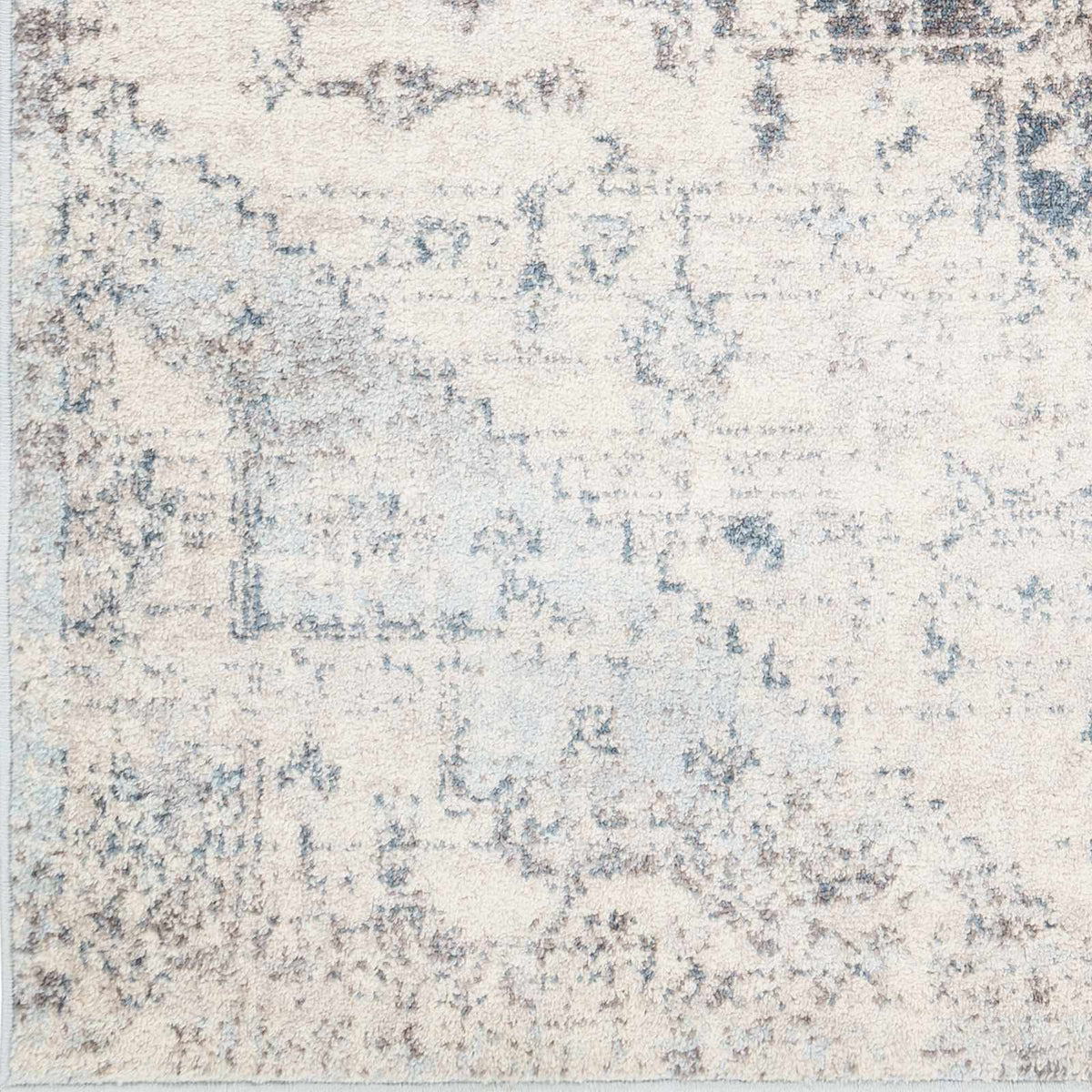 Hauteloom Orrick area rug swatch with intricate geometric patterns in neutral tones, showcasing soft fabric texture.