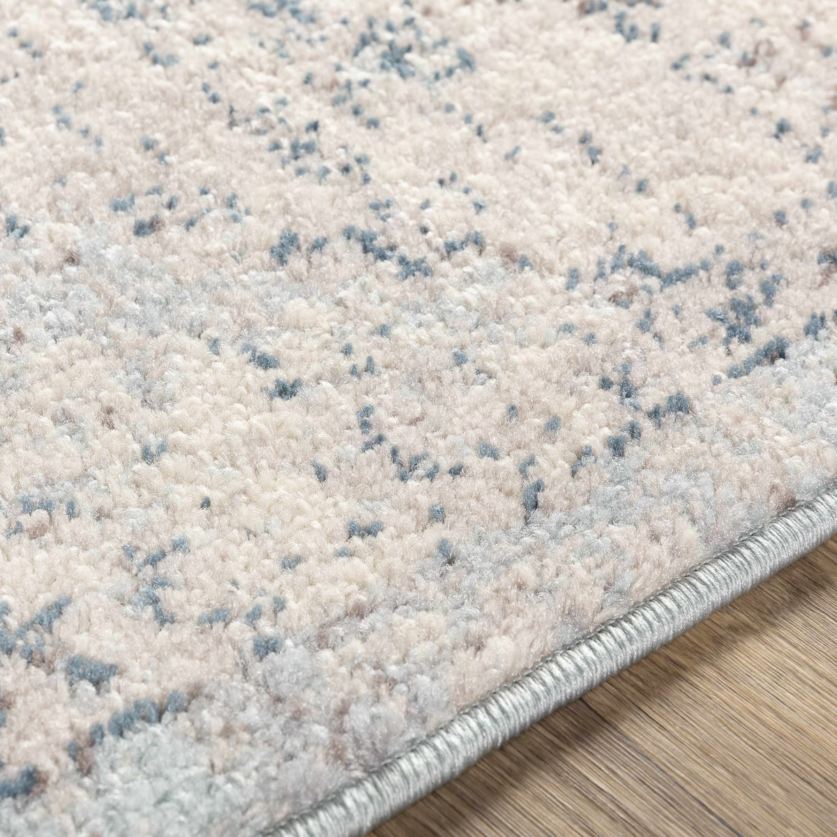 Hauteloom Orrick area rug with textured pattern in neutral tones, showcasing soft woven fabric and intricate design details.