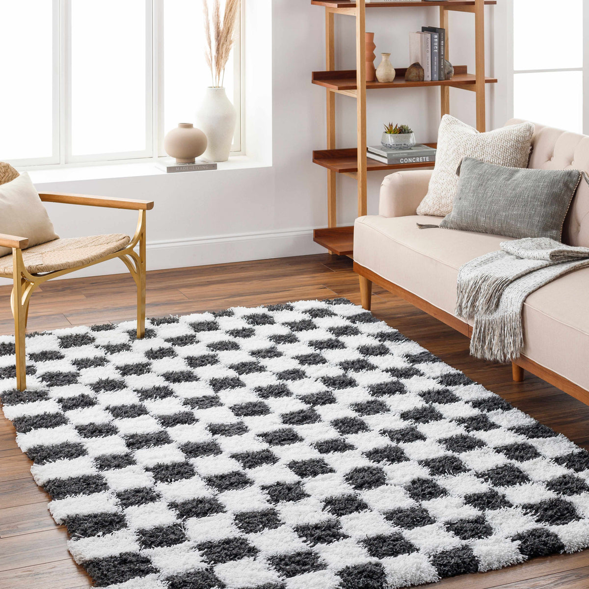 Black and white checkered area rug by Boutique Rugs, featuring a modern checkered pattern in a cozy room setting.