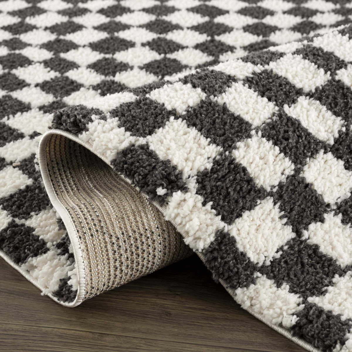 Black and white checkered shag rug from Boutique Rugs, featuring a plush, textured surface with a modern geometric pattern.