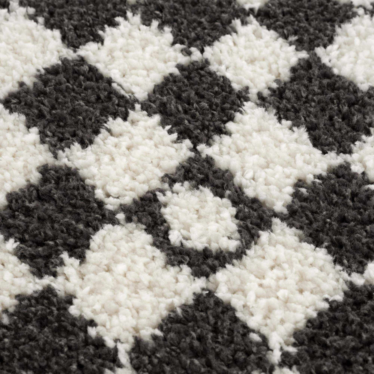 Black and white checkered shag rug by Boutique Rugs with soft, textured fibers, perfect for adding modern style to a room.