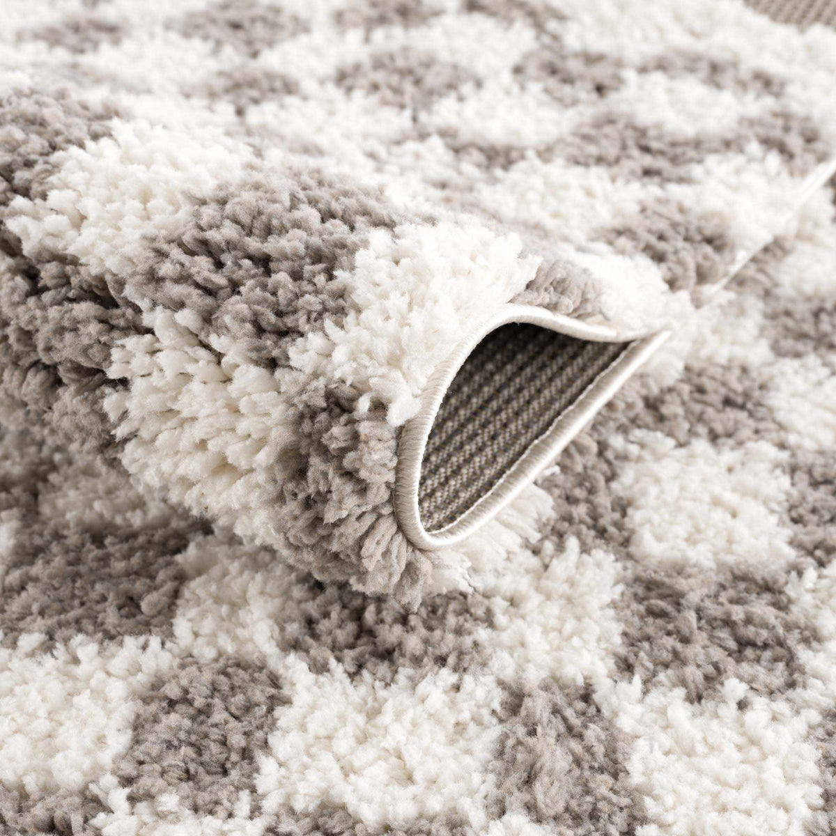 Taupe checkered plush rug by Boutique Rugs, showcasing soft textured fabric and modern checkered pattern in a cozy, stylish design.