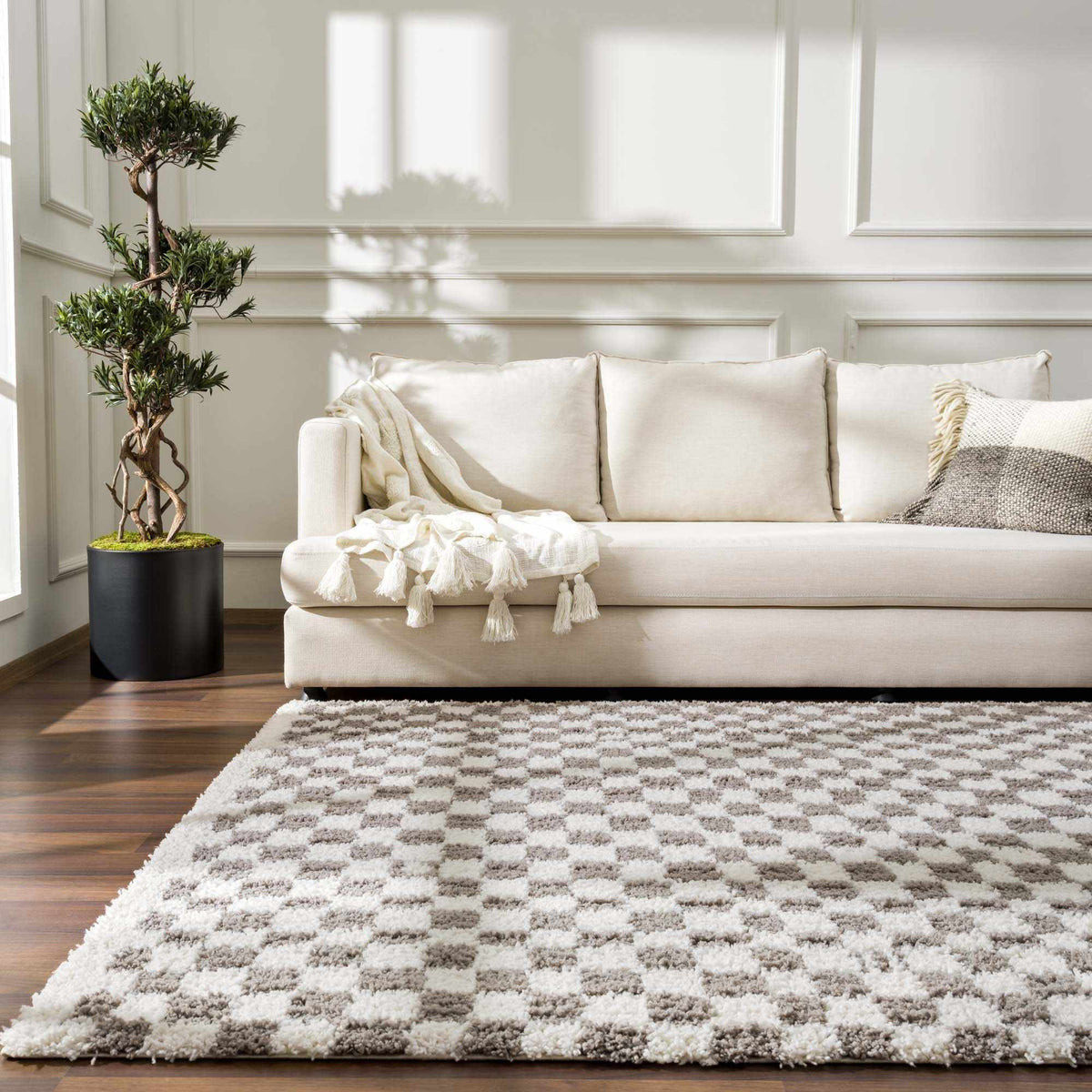 Taupe checkered plush rug from Boutique Rugs, styled in a cozy room scene with soft textures and modern pattern.