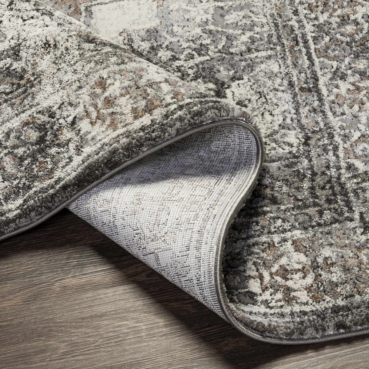 Charcoal Luxe Thick Area Rug from Boutique Rugs, folded to show plush texture and rich color in a modern living space.