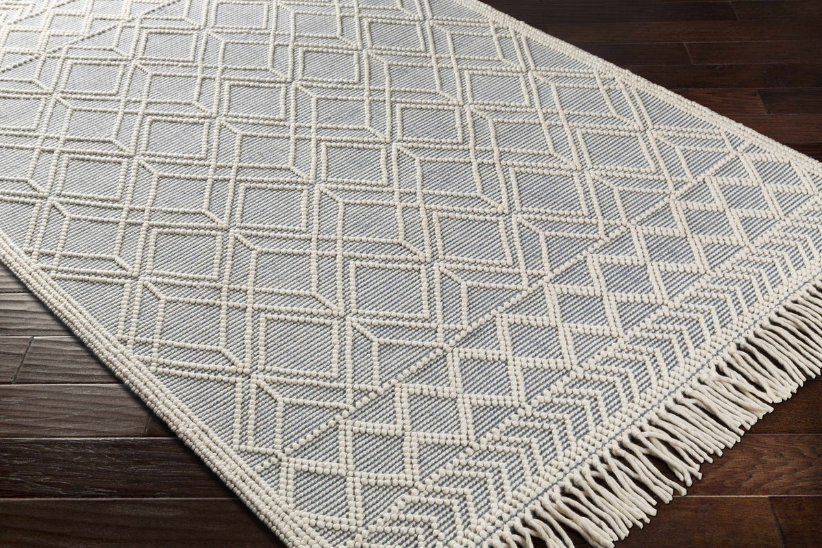Corner view of Hauteloom Ramsbury Ivory and Blue Area Rug, showcasing intricate patterns and soft texture.