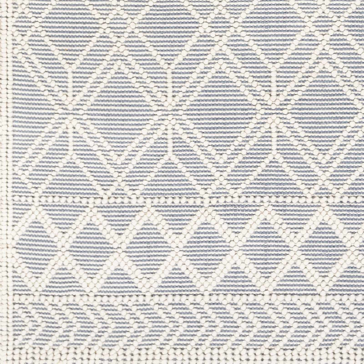 Swatch image of Hauteloom Ramsbury Ivory and Blue Area Rug showing intricate pattern and soft textile texture.