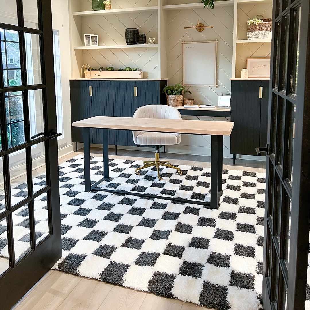 Black and white checkered area rug from Boutique Rugs with a farmhouse style pattern and soft woven texture.