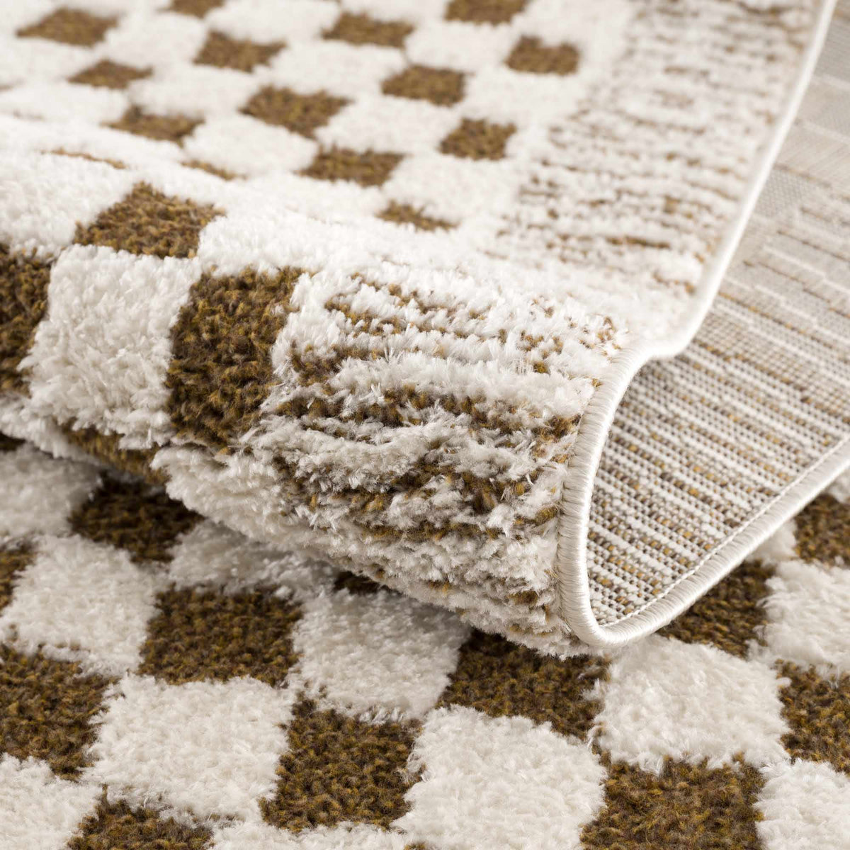 Leryn Brown Checkered Plush Rug from Boutique Rugs, folded to show soft, plush fabric and classic checkered pattern in warm brown tones.
