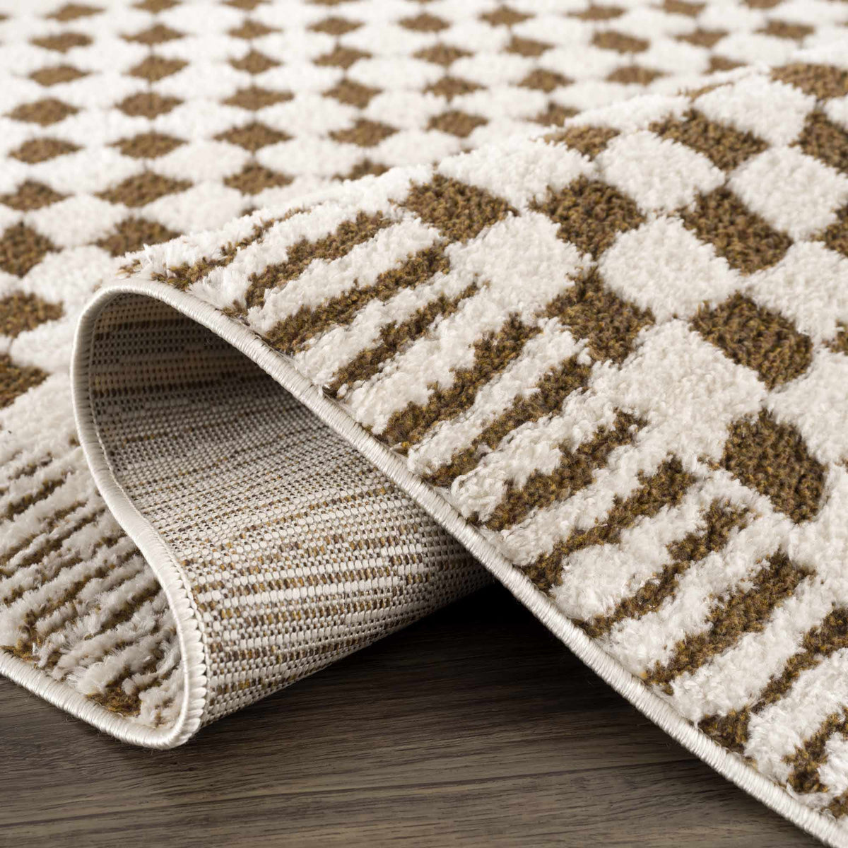 Boutique Rugs Leryn Brown Checkered Plush Rug with soft, cozy texture and brown checkered pattern, folded to show plush material.