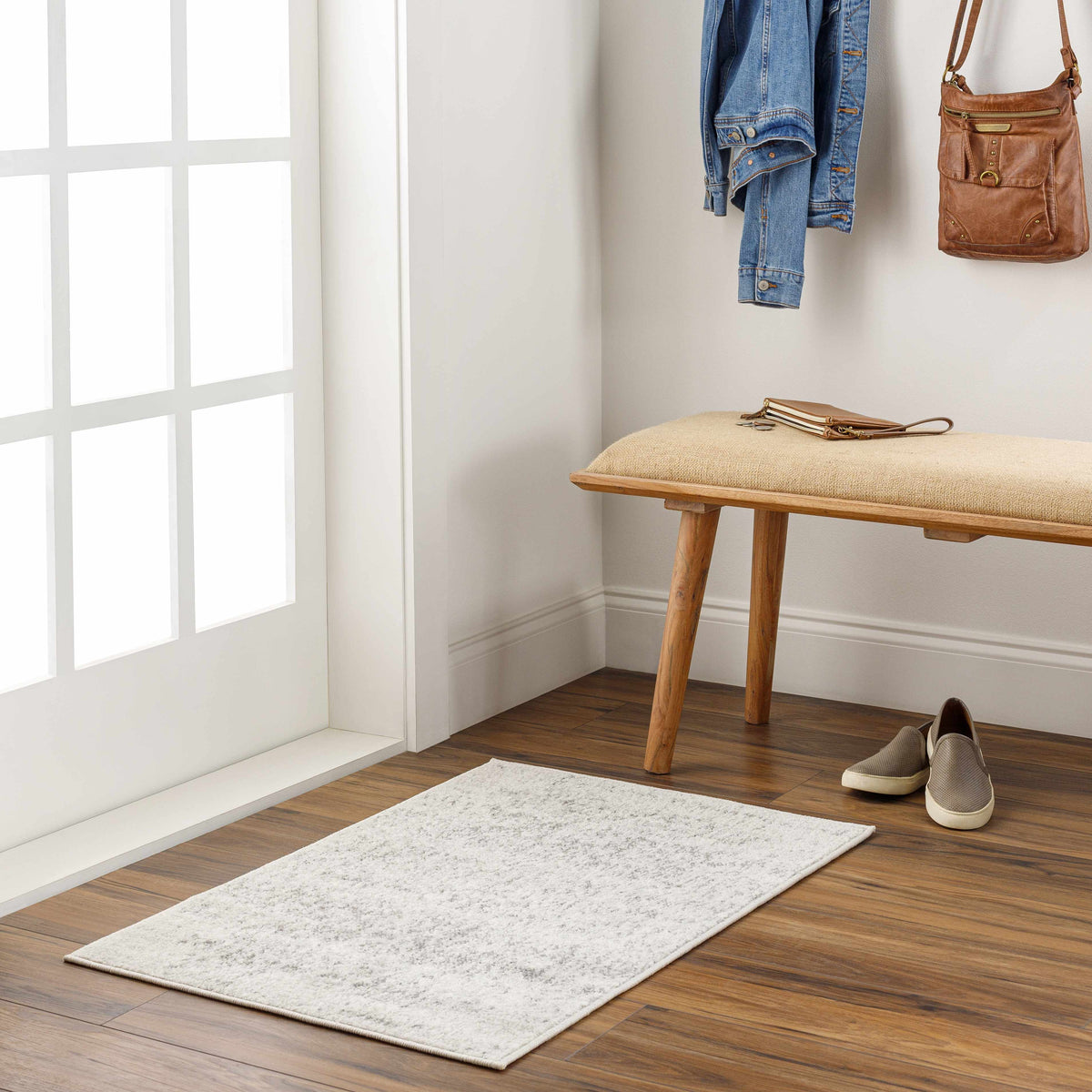 Hauteloom Rachel area rug with a patterned design, shown in a cozy room setting with furniture and decorative accents.