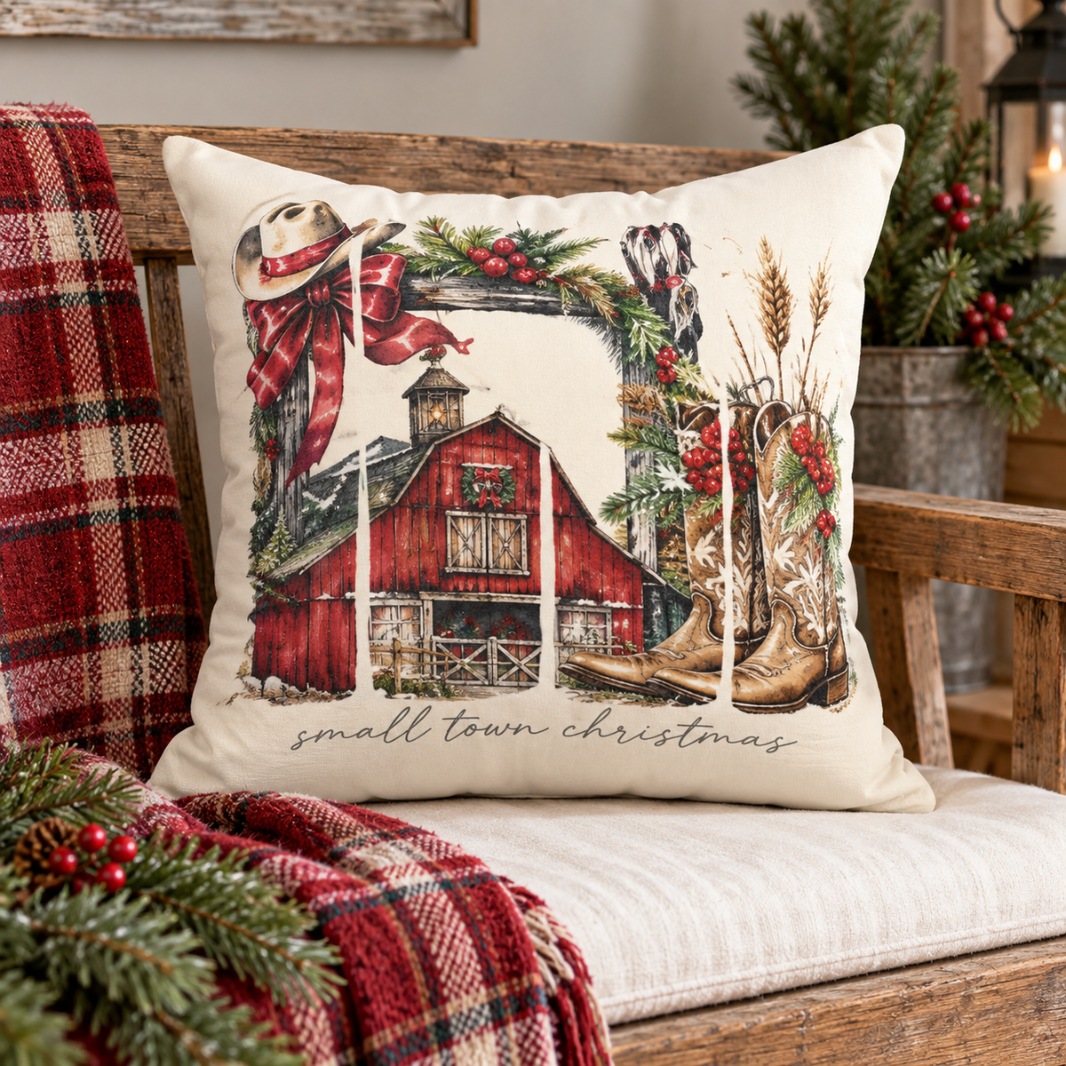 Farmhouse Christmas throw pillow featuring barn and cowboy boots design by Kraft Paper Scissors, perfect for home decor.
