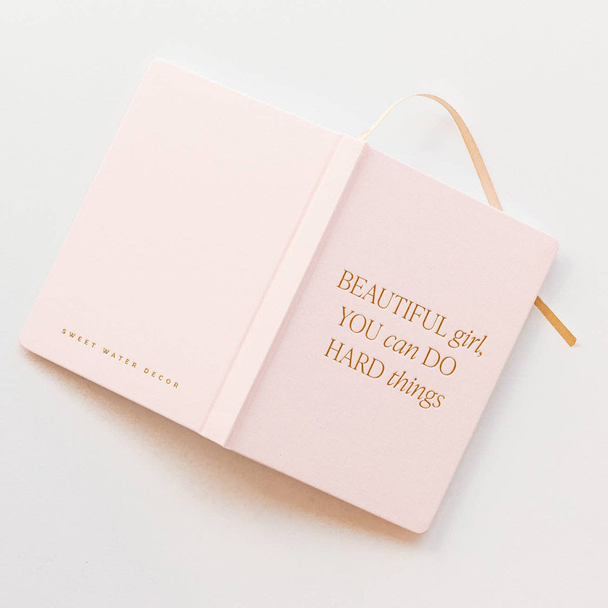 Pink fabric journal titled "Beautiful Girl, You Can Do Hard Things" by BlackbirdOak, featuring kraft paper pages and a soft cover.