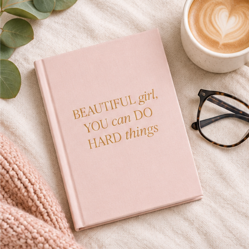 Pink fabric journal titled "Beautiful Girl, You Can Do Hard Things" by BlackbirdOak, featuring kraft paper cover and scissors illustration.