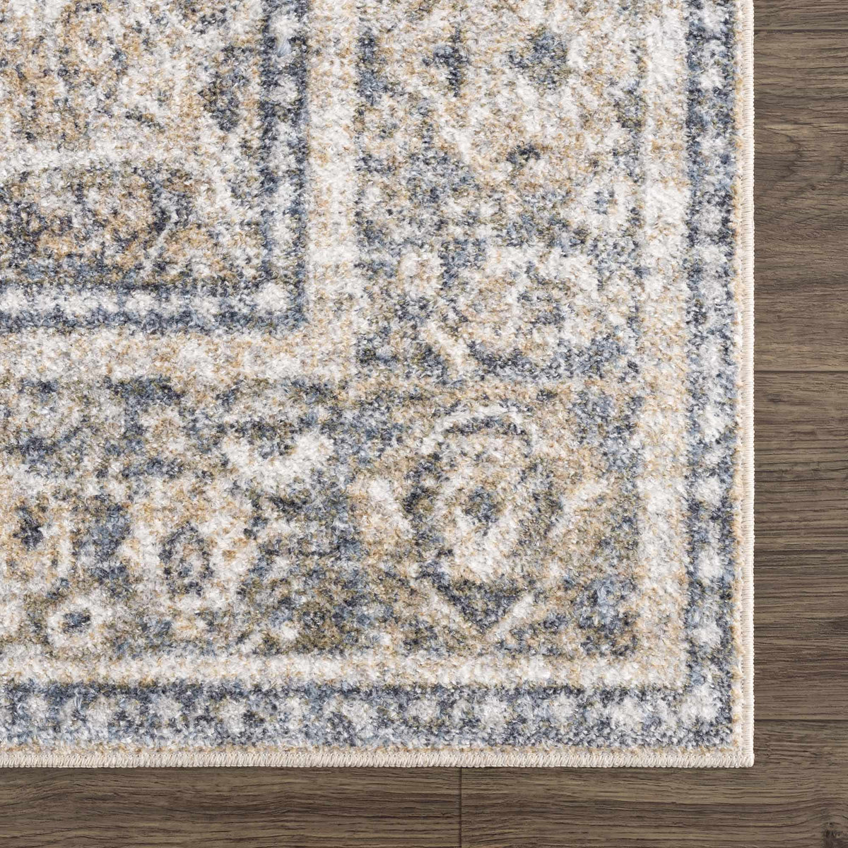 Corner view of a washable rug from Arias Boutique Rugs featuring intricate patterns and soft textures in neutral tones.