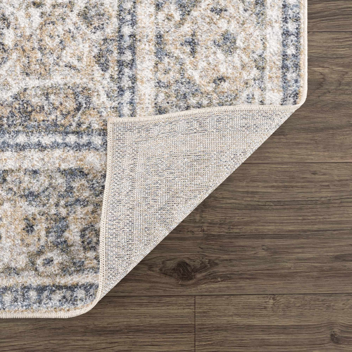 Folded washable rug from Arias Boutique Rugs featuring a soft, textured surface in neutral tones.