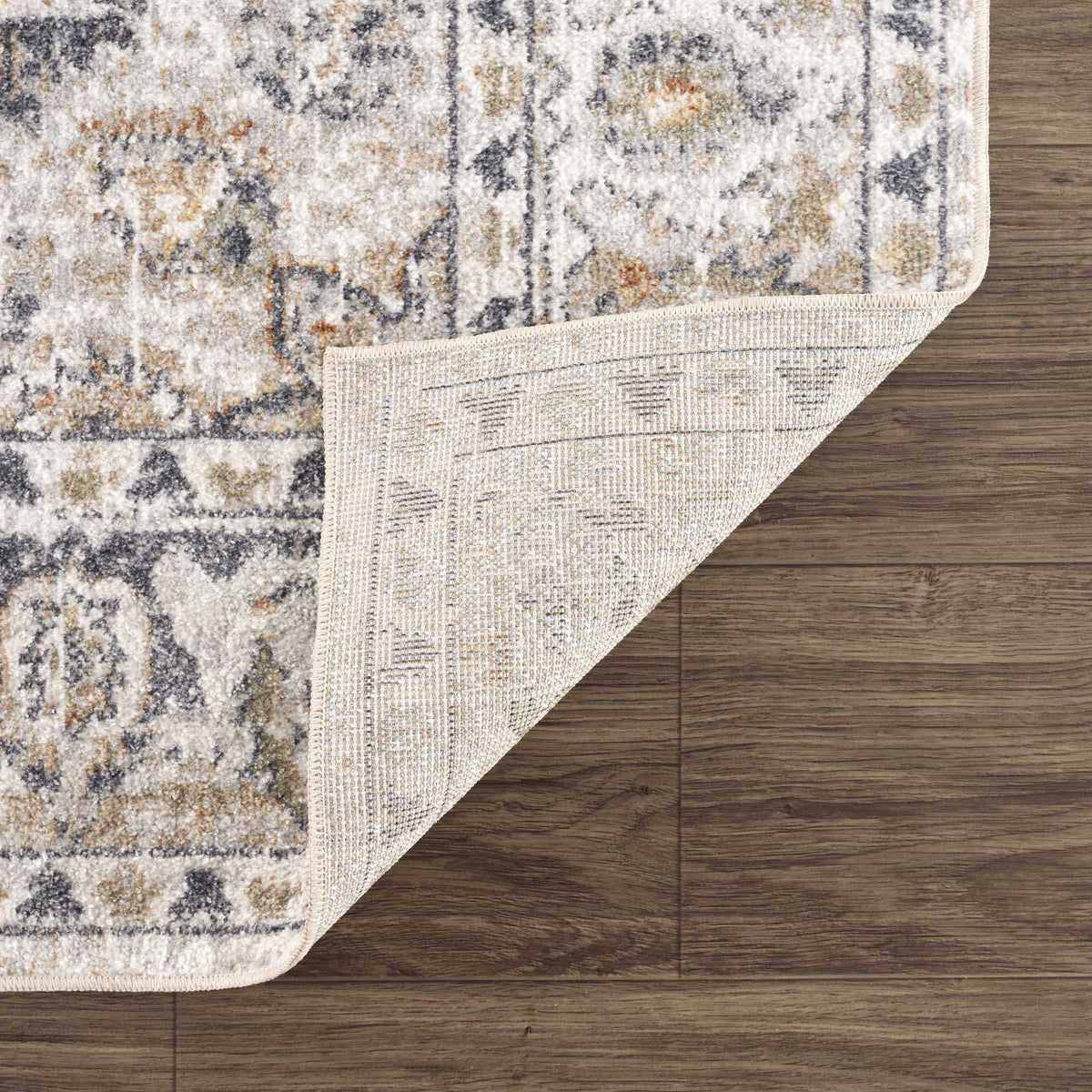 Boutique Rugs Hiti Cream flat pile washable rug folded on a surface, showcasing its soft texture and neutral cream color.