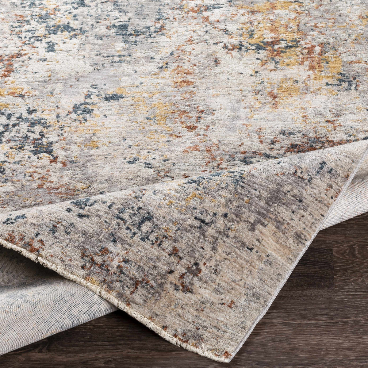 Lydney Luxe Rug by Boutique Rugs folded to show intricate patterns and plush texture in soft, neutral tones.