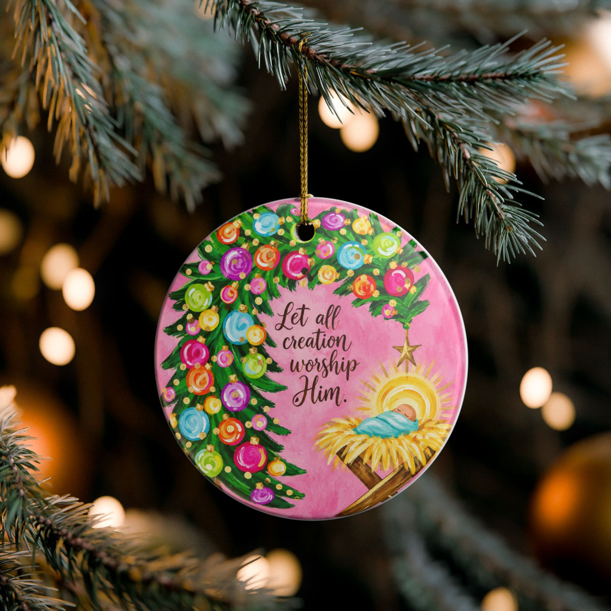 Ceramic Christmas ornament featuring nativity scene and "Let All Creation Worship Him" message, ideal for home holiday decor.